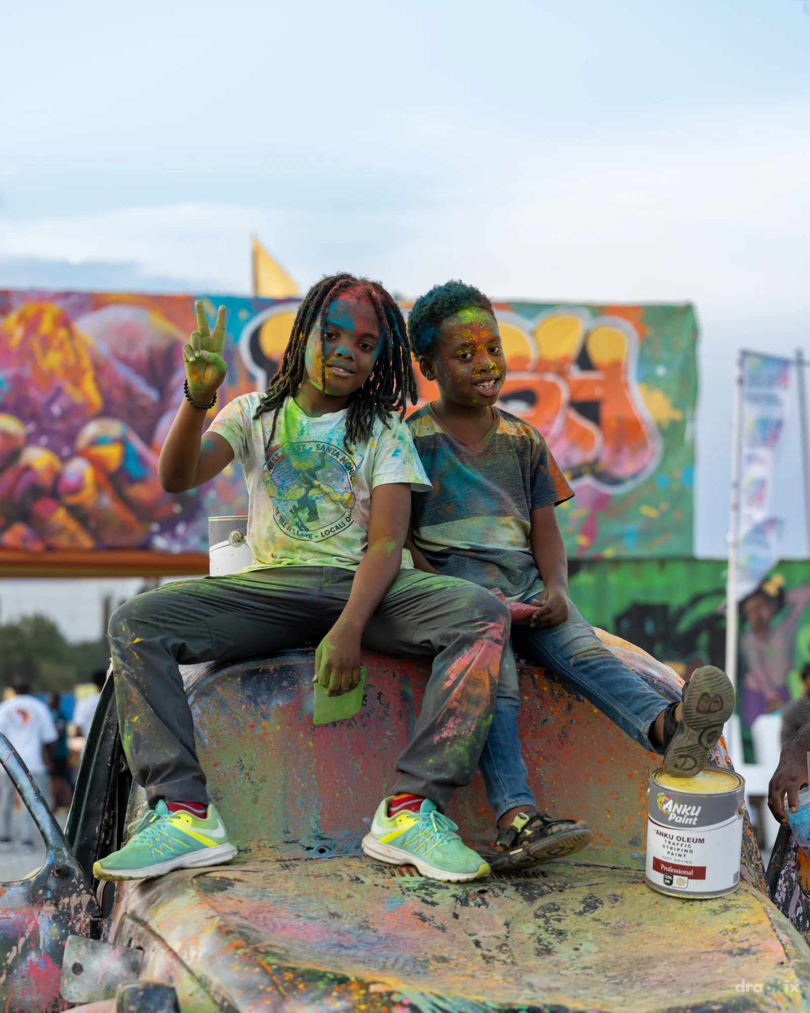 Children seated on a painted car