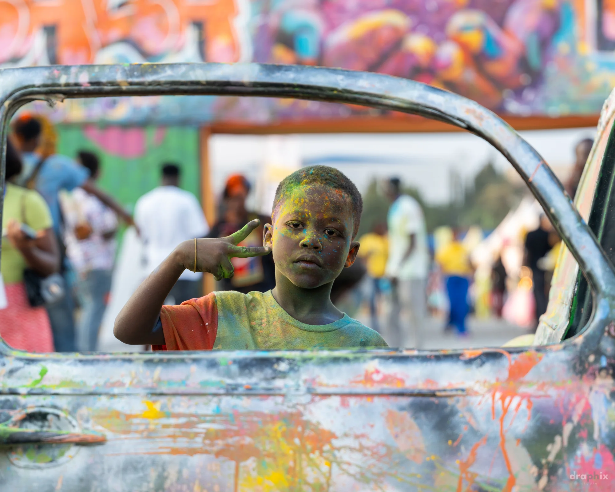 Child framed in a painted car window