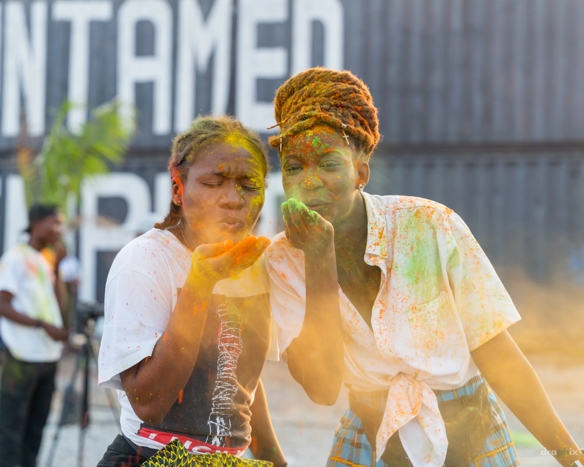 Friends blowing color powder