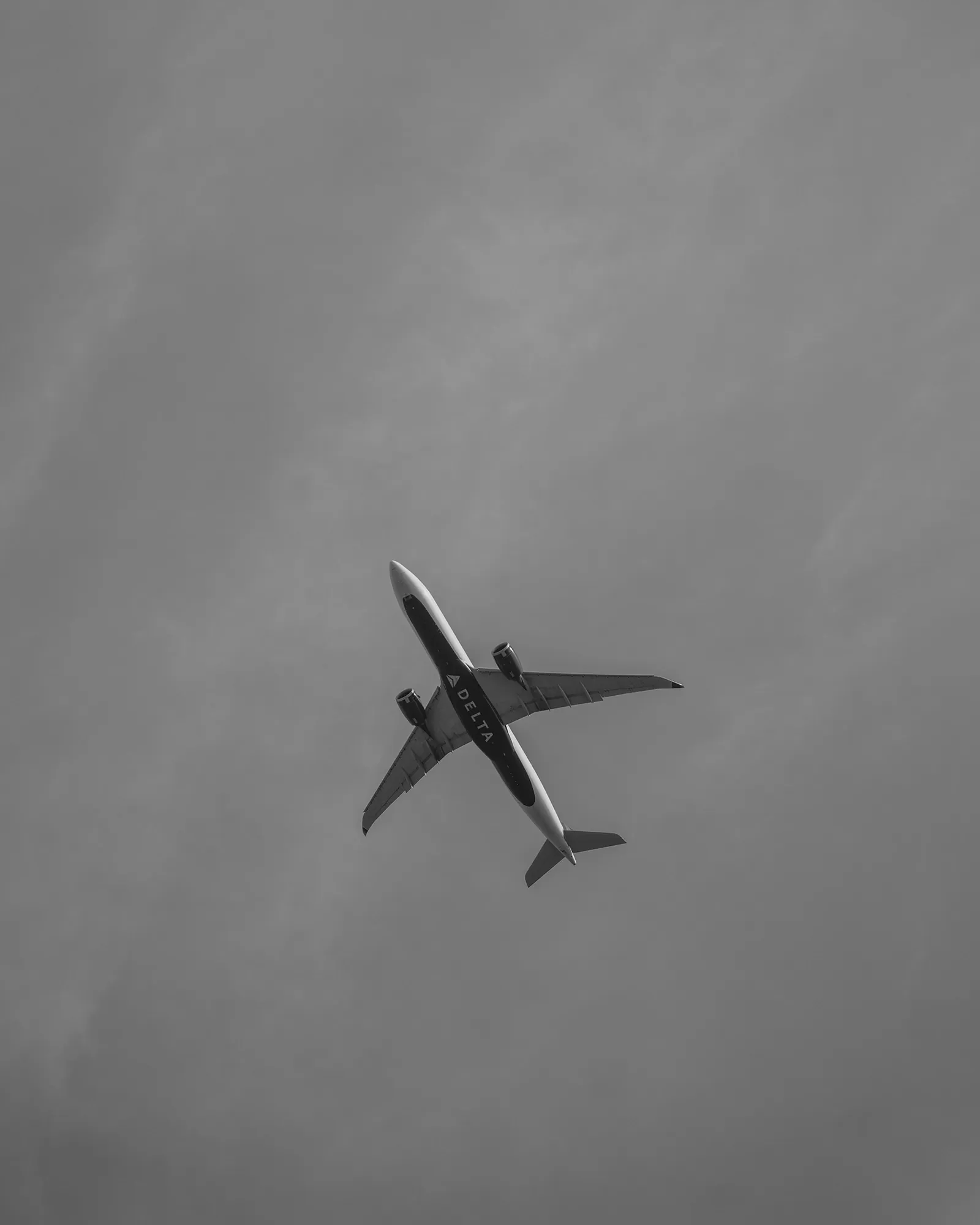 Airplane against gray sky