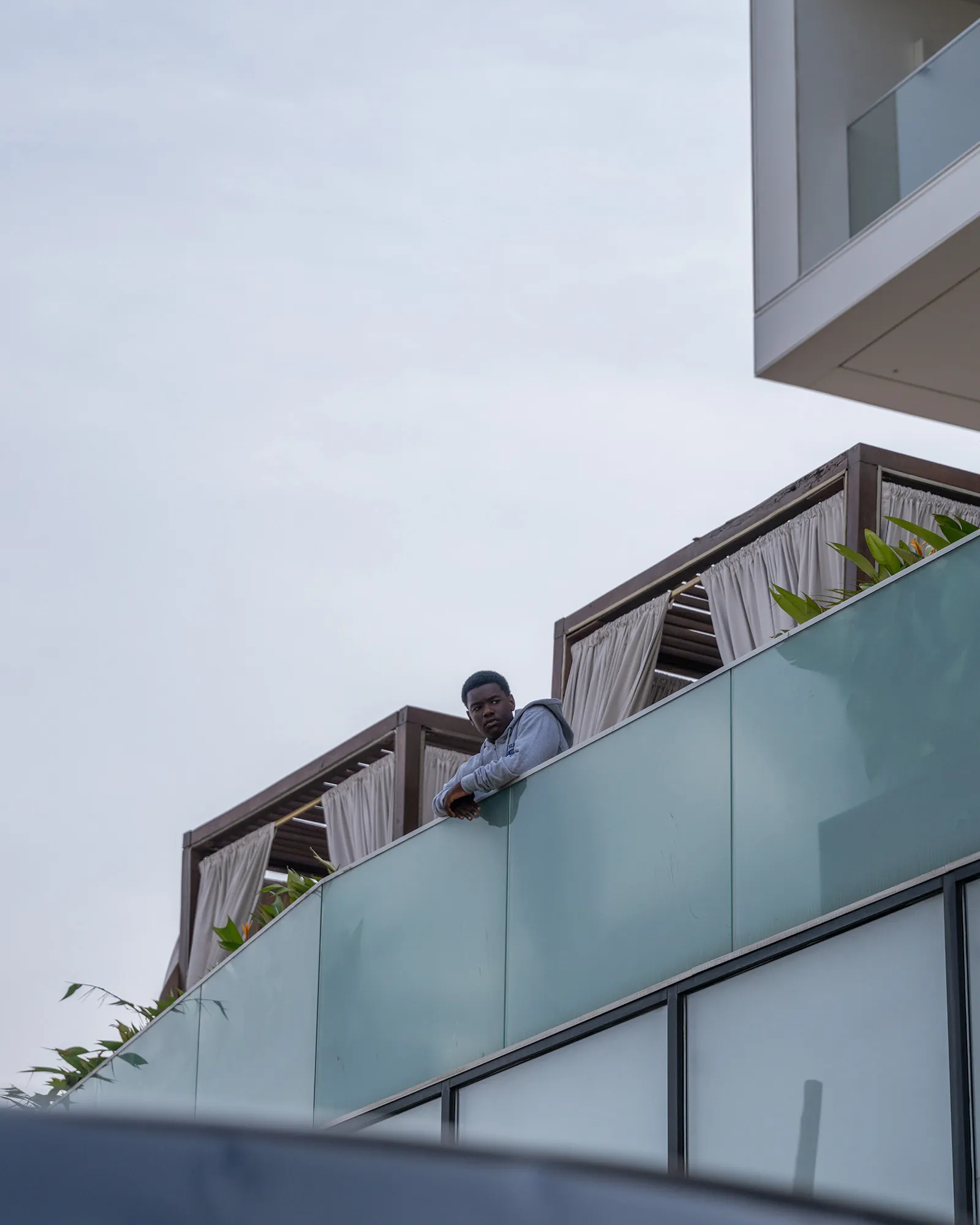 Man leaning over a balcony