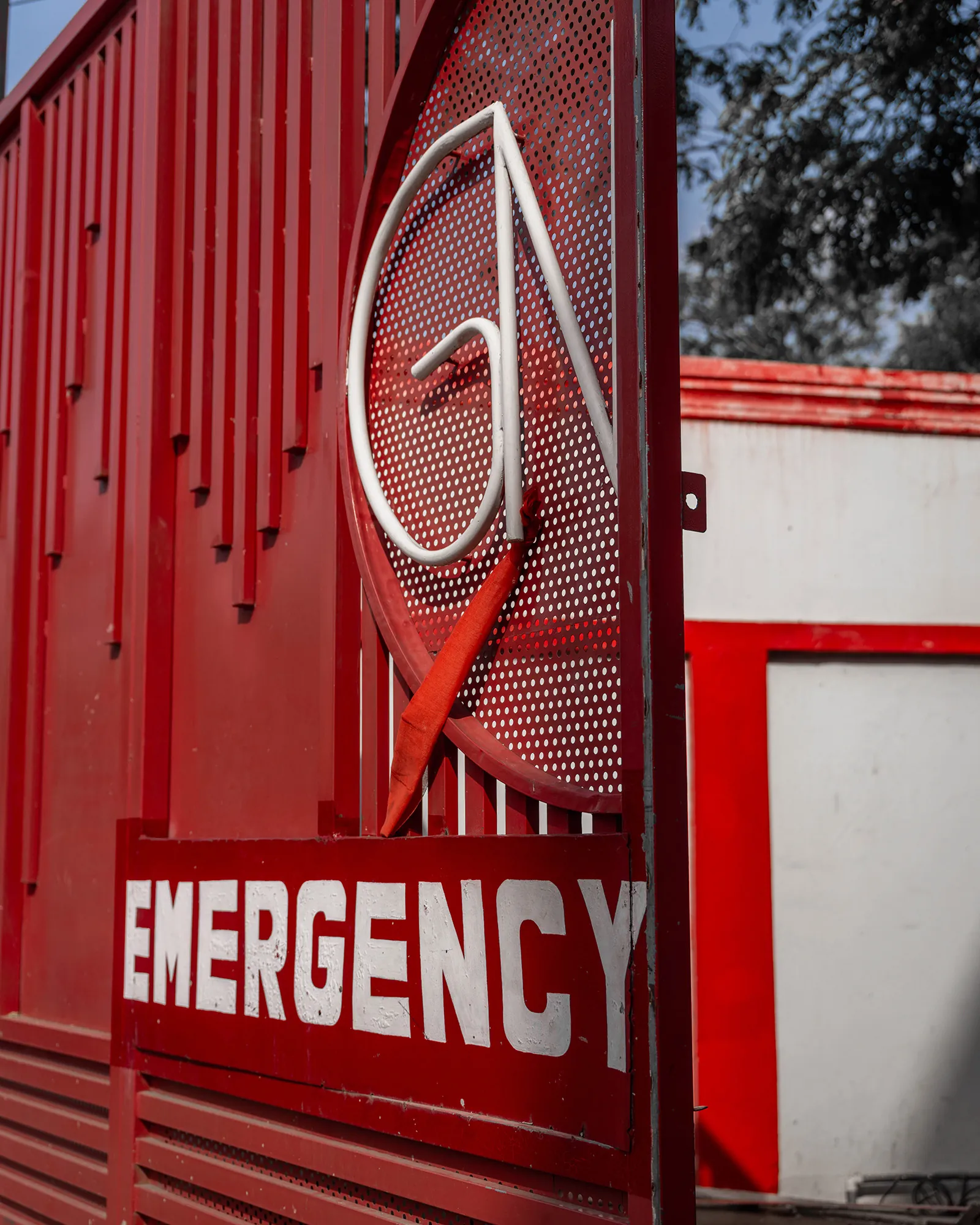 Emergency sign on a red gate
