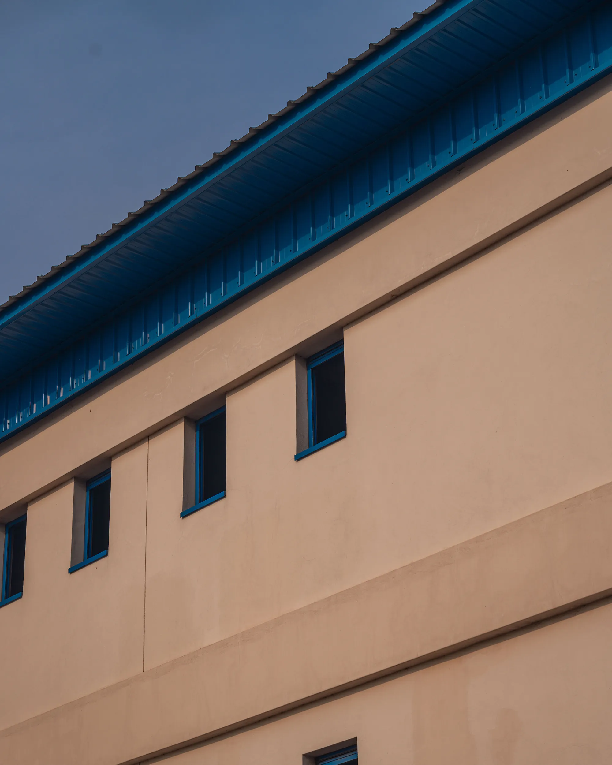 Blue roofline and beige wall