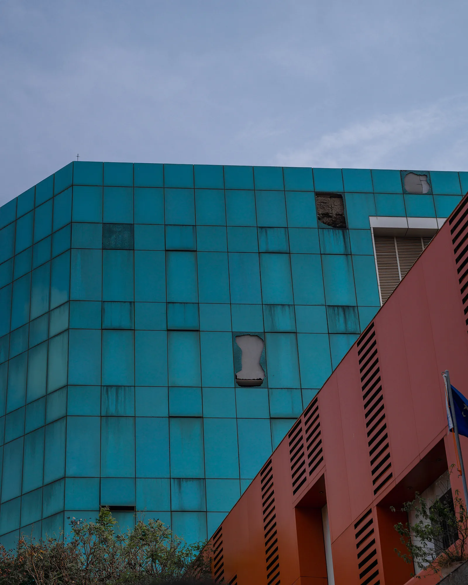Turquoise facade and red building